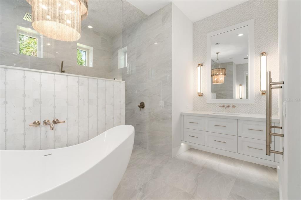 8679 Southwest 28 Lane Gainesville, FL 32608 - Photo 22 of 64 a spacious bathroom with a double vanity sink a mirror a bathtub and