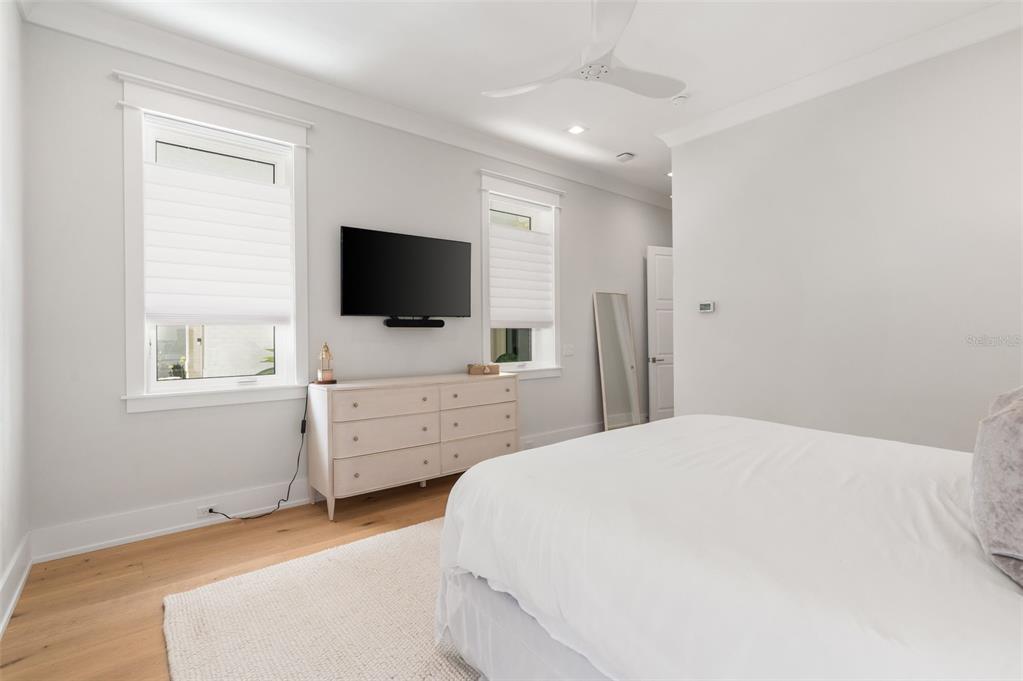 8679 Southwest 28 Lane Gainesville, FL 32608 - Photo 29 of 64 a bedroom with a bed and flat screen tv