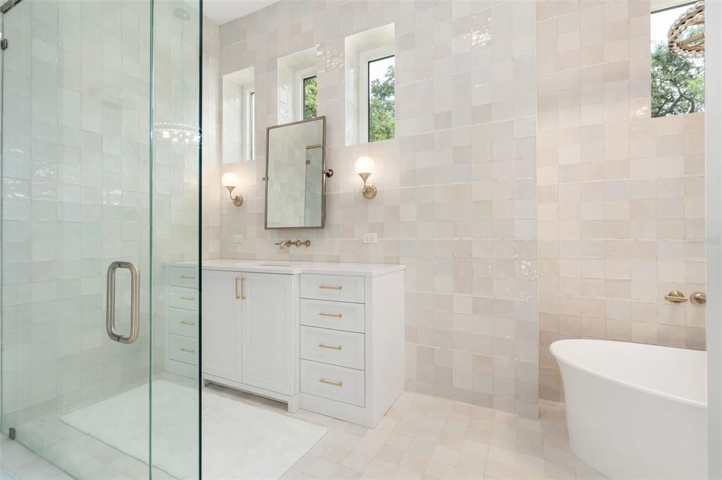 8679 Southwest 28 Lane Gainesville, FL 32608 - Photo 30 of 64 a bathroom with a shower sink and mirror