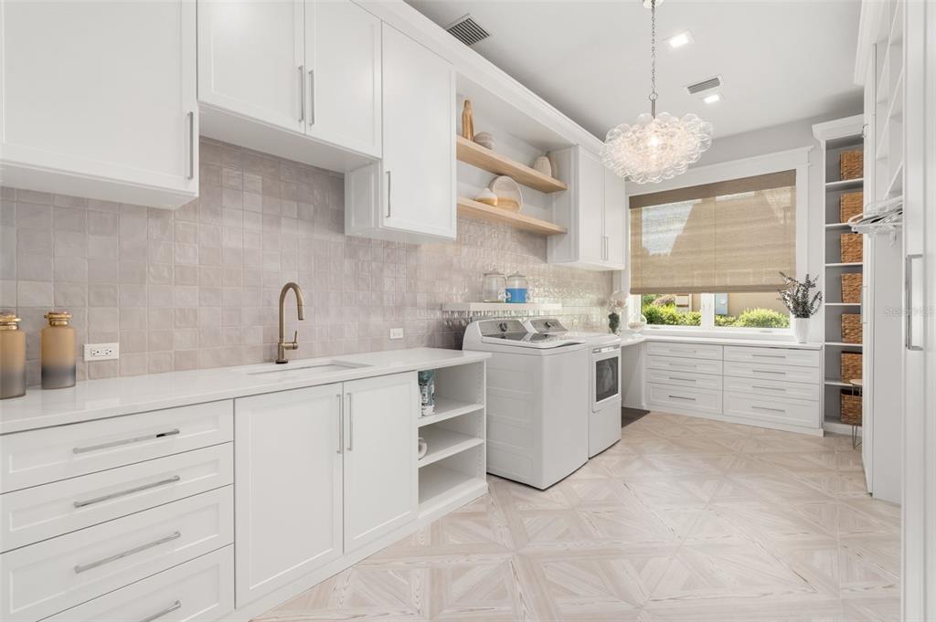 8679 Southwest 28 Lane Gainesville, FL 32608 - Photo 38 of 64 a kitchen with white cabinets and white appliances