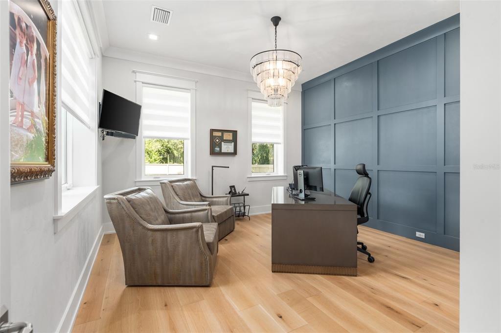 8679 Southwest 28 Lane Gainesville, FL 32608 - Photo 40 of 64 a living room with furniture and a chandelier