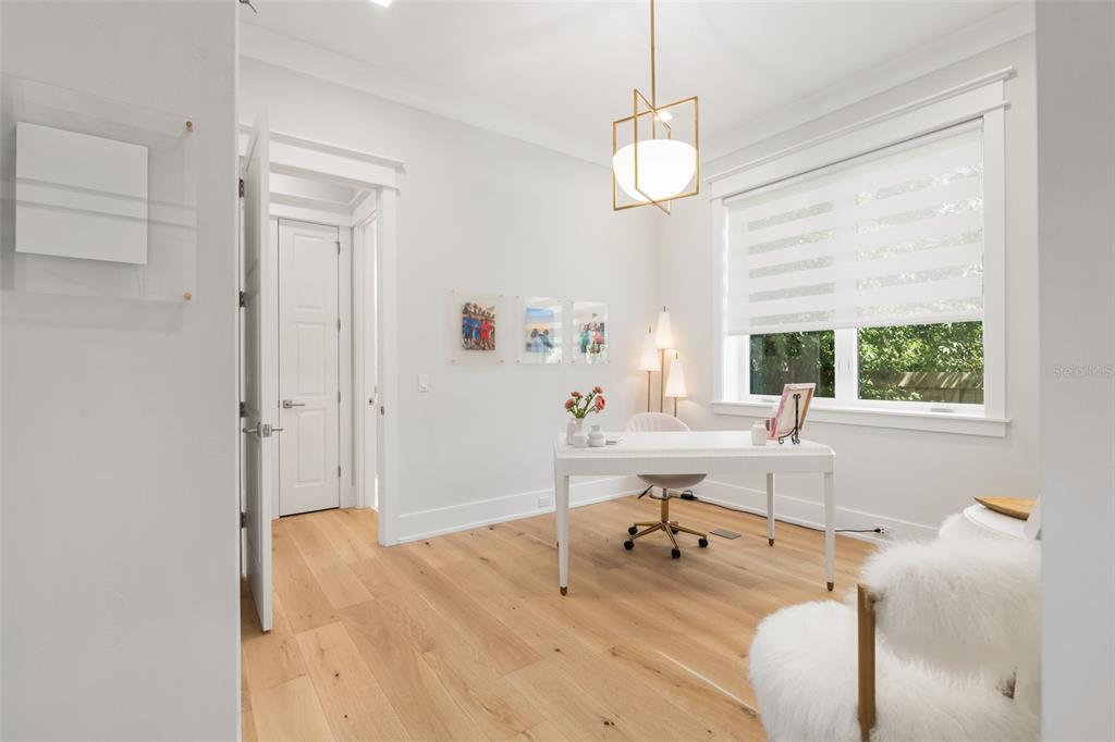 8679 Southwest 28 Lane Gainesville, FL 32608 - Photo 41 of 64 a work room with wooden floor and windows