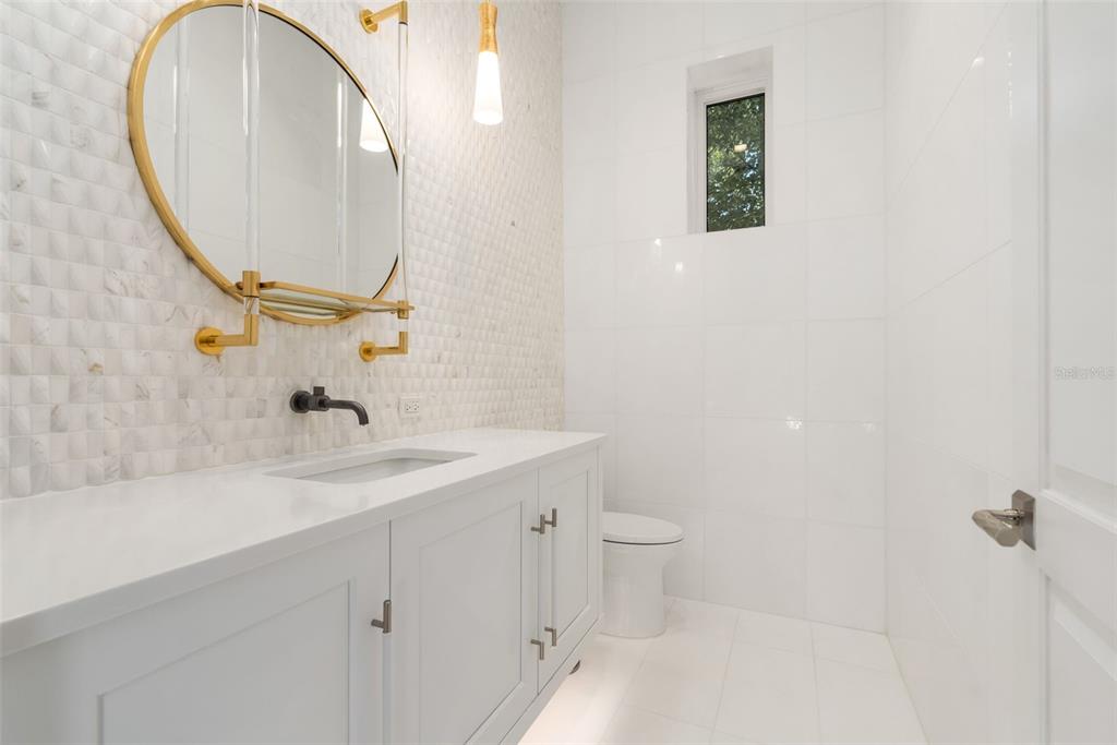 8679 Southwest 28 Lane Gainesville, FL 32608 - Photo 43 of 64 a bathroom with a sink and a mirror