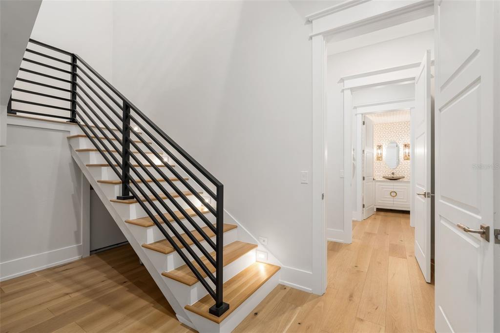 8679 Southwest 28 Lane Gainesville, FL 32608 - Photo 44 of 64 a view of a hallway with wooden floor and staircase