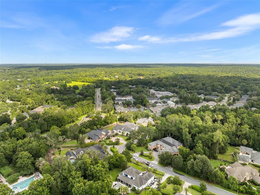8679 Southwest 28 Lane Gainesville, FL 32608 - Photo 57 of 64 an aerial view of residential houses with outdoor space and trees