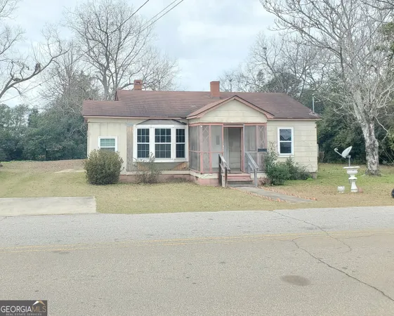a front view of a house with a garden
