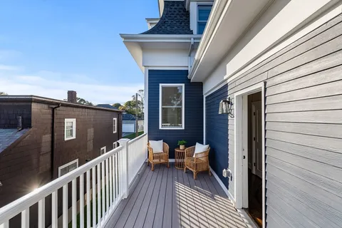 a view of a balcony with furniture