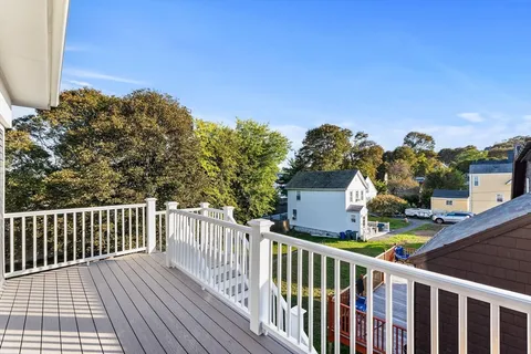 a view of a balcony with wooden fence