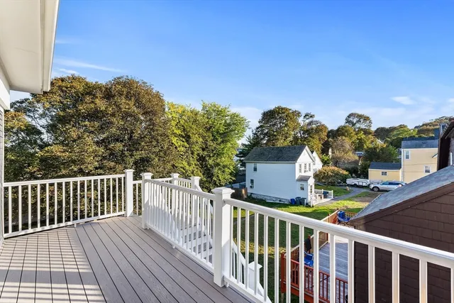 a view of a balcony with wooden fence