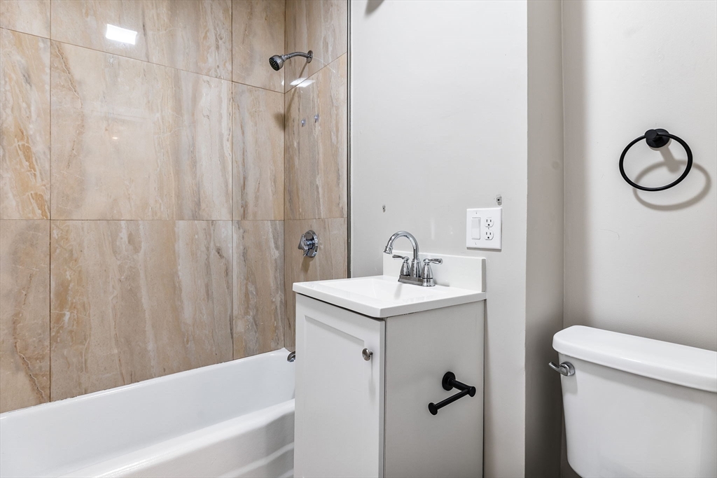 62 Chestnut Street, Unit 4 Saugus, MA 01906 - Photo 8 of 16 a bathroom with a sink a toilet and a tub