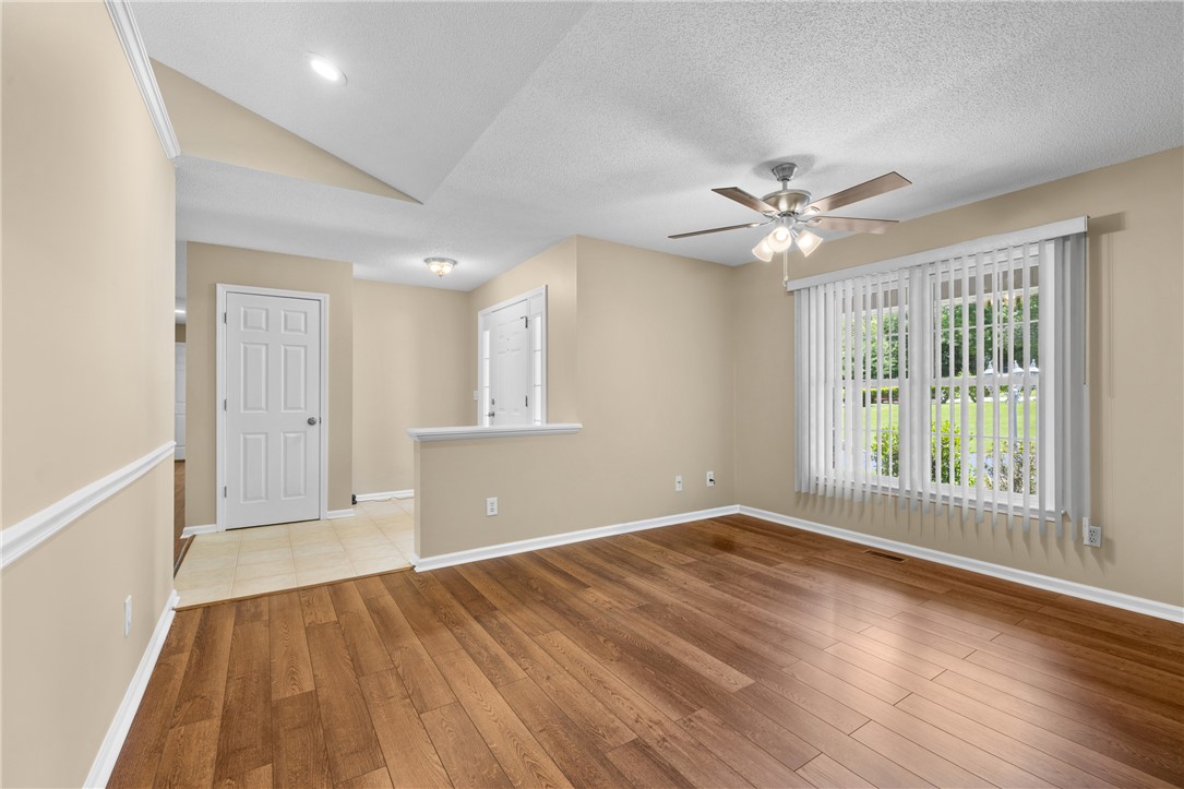 429 Burns Mill Road West Union, SC 29696 - Photo 7 of 49 Rich hardwood flooring complements soaring ceilings and generous natural light in this inviting living space.