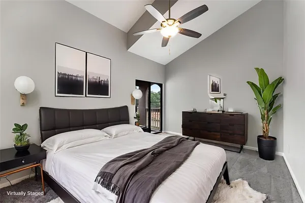 a bedroom with a large bed and a chandelier
