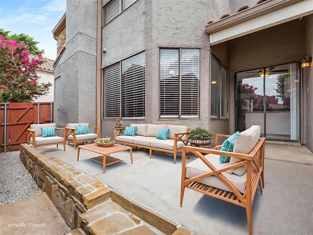 a backyard of a house with outdoor seating
