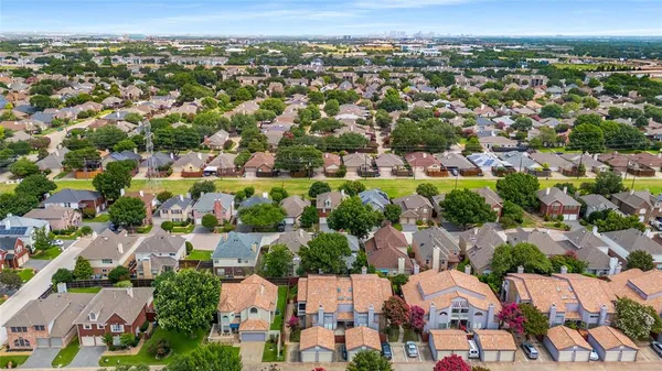an aerial view of residential houses with city view