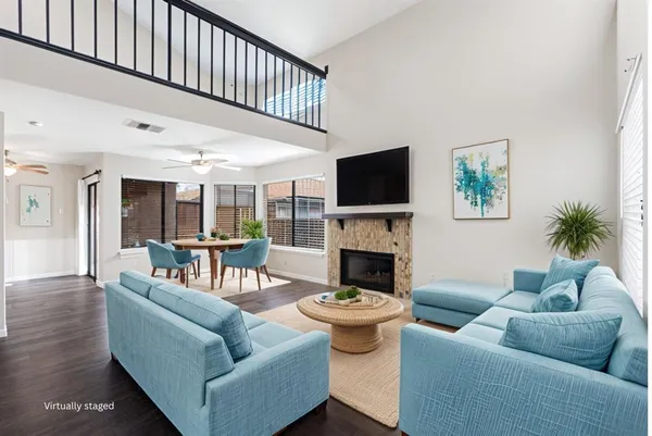a living room with furniture a fireplace and a flat screen tv