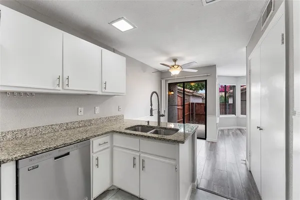 a kitchen with cabinets and window