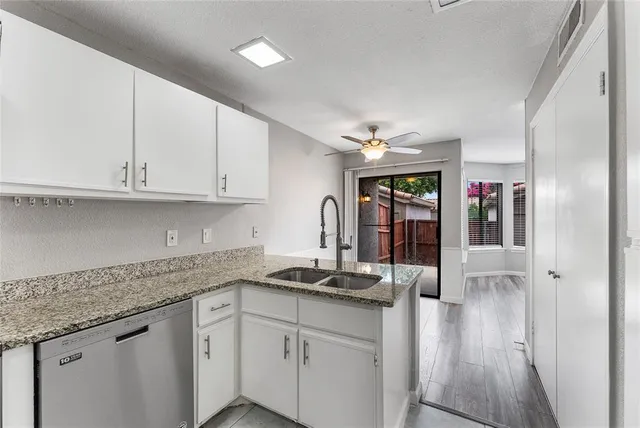 a kitchen with cabinets and window