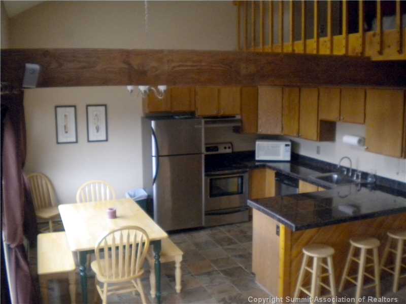 9876 Ryan Gulch Road, Unit 303F Silverthorne, CO 80498 - Photo 2 of 22 Kitchen. Pretty slate floors, granite tile counters and stainless appliances!
