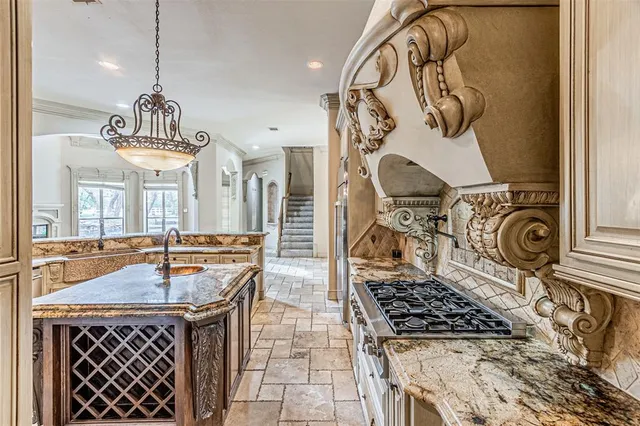 a kitchen with a stove a sink and a table