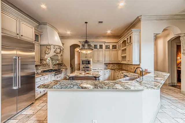 a kitchen with granite countertop a sink stainless steel appliances and cabinets