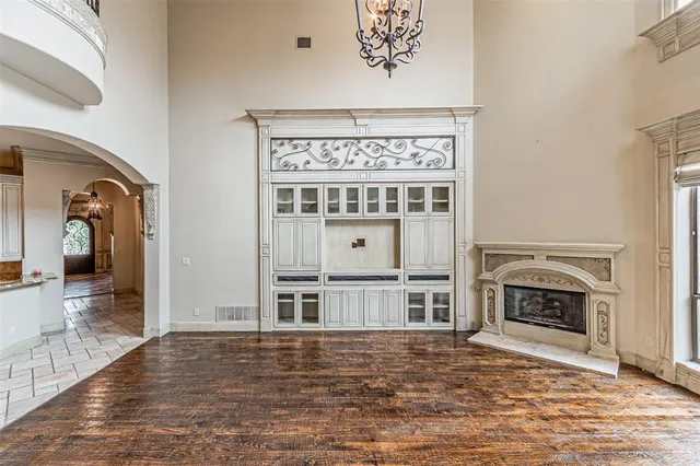 a view of a livingroom with a fireplace wooden floor and cabinet
