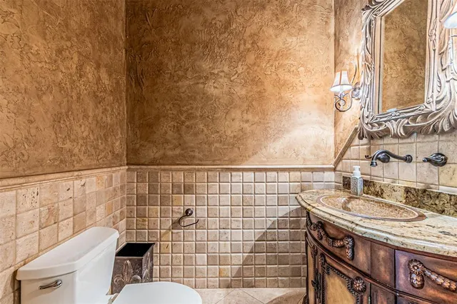 a bathroom with a sink a toilet and shower curtain