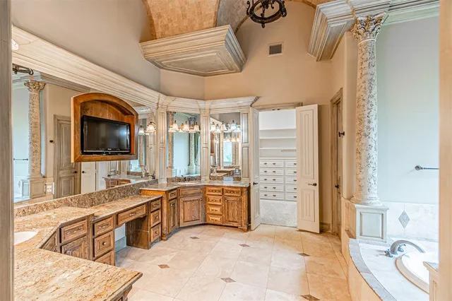 a large bathroom with a tub sink and mirror