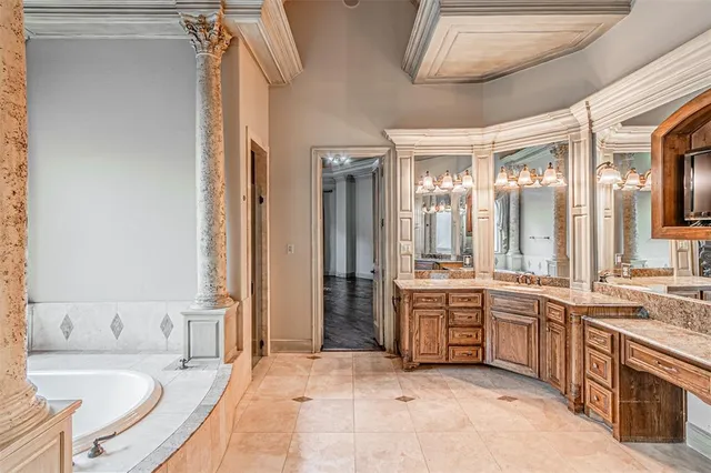 a large bathroom with a granite countertop tub sink shower and mirror