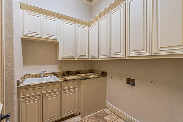 a kitchen with granite countertop white cabinets and sink