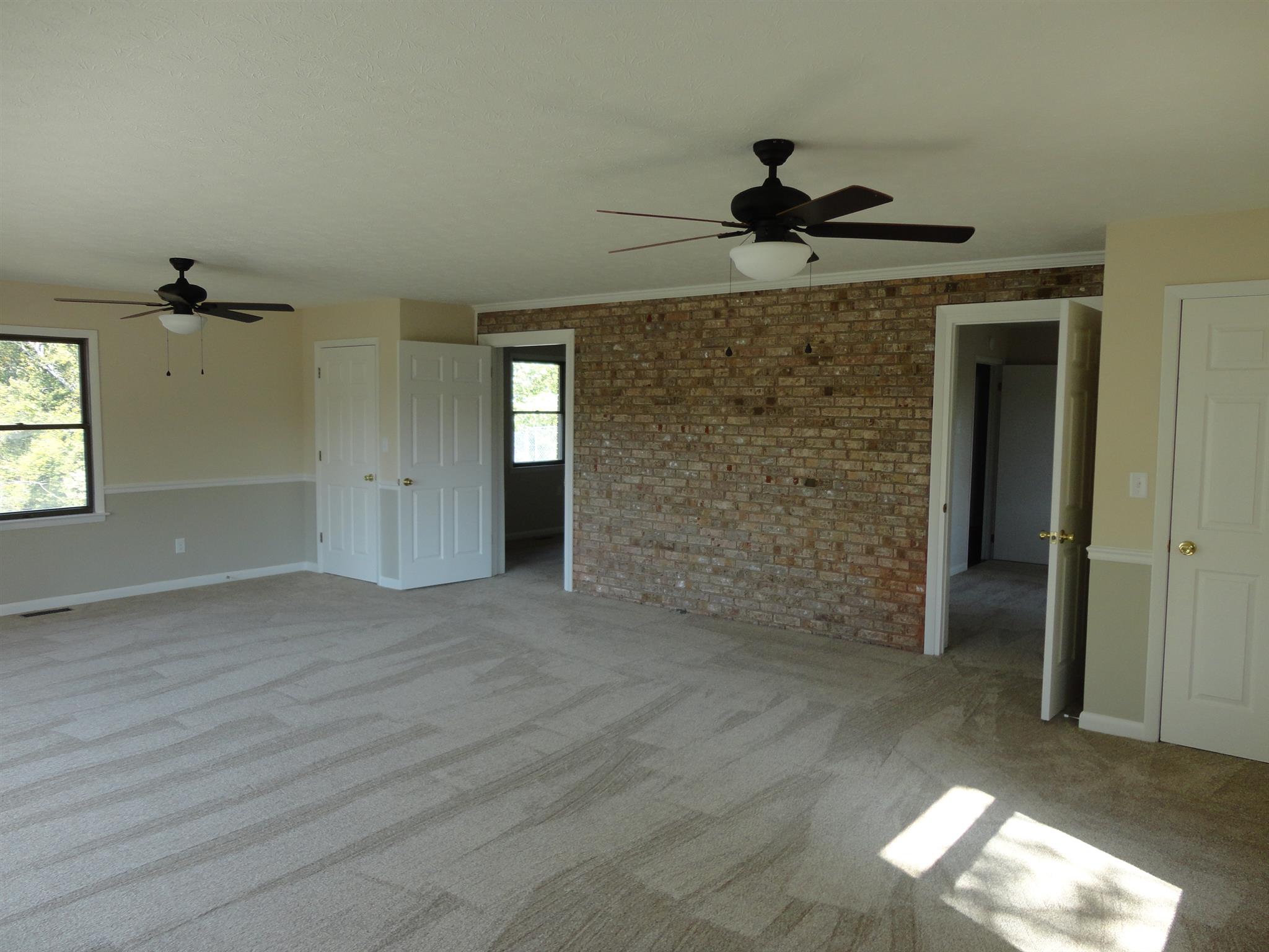 1665 Johnson Chapel Road Sparta, TN 38583 - Photo 11 of 26 Accent wall in master bedroom is brick