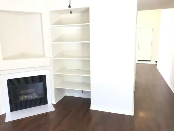 a living room with a fireplace and a floor to ceiling window