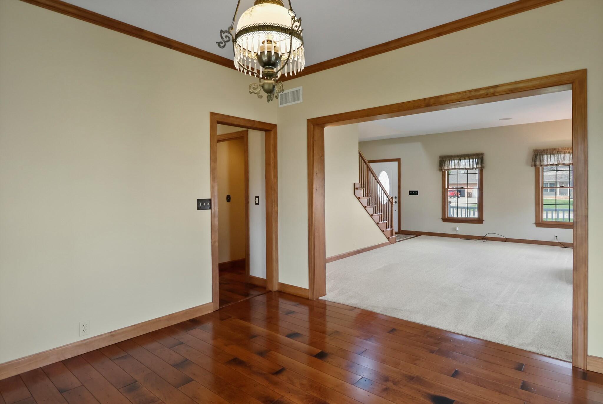 172 Lee Drive Kouts, IN 46347 - Photo 13 of 63 a view of a hallway with wooden floor and chandelier
