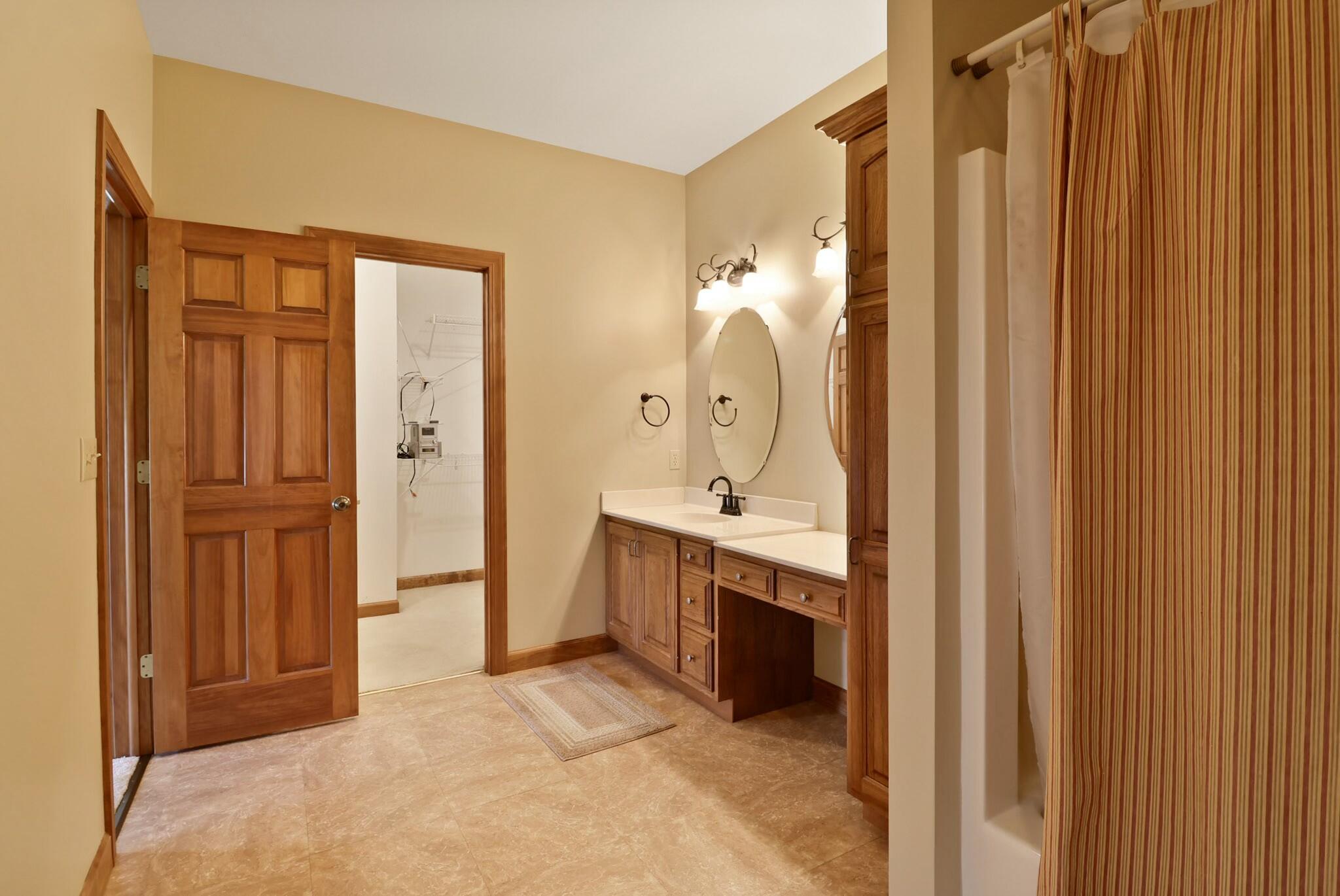 172 Lee Drive Kouts, IN 46347 - Photo 21 of 63 a large bathroom with a double vanity sink and mirror