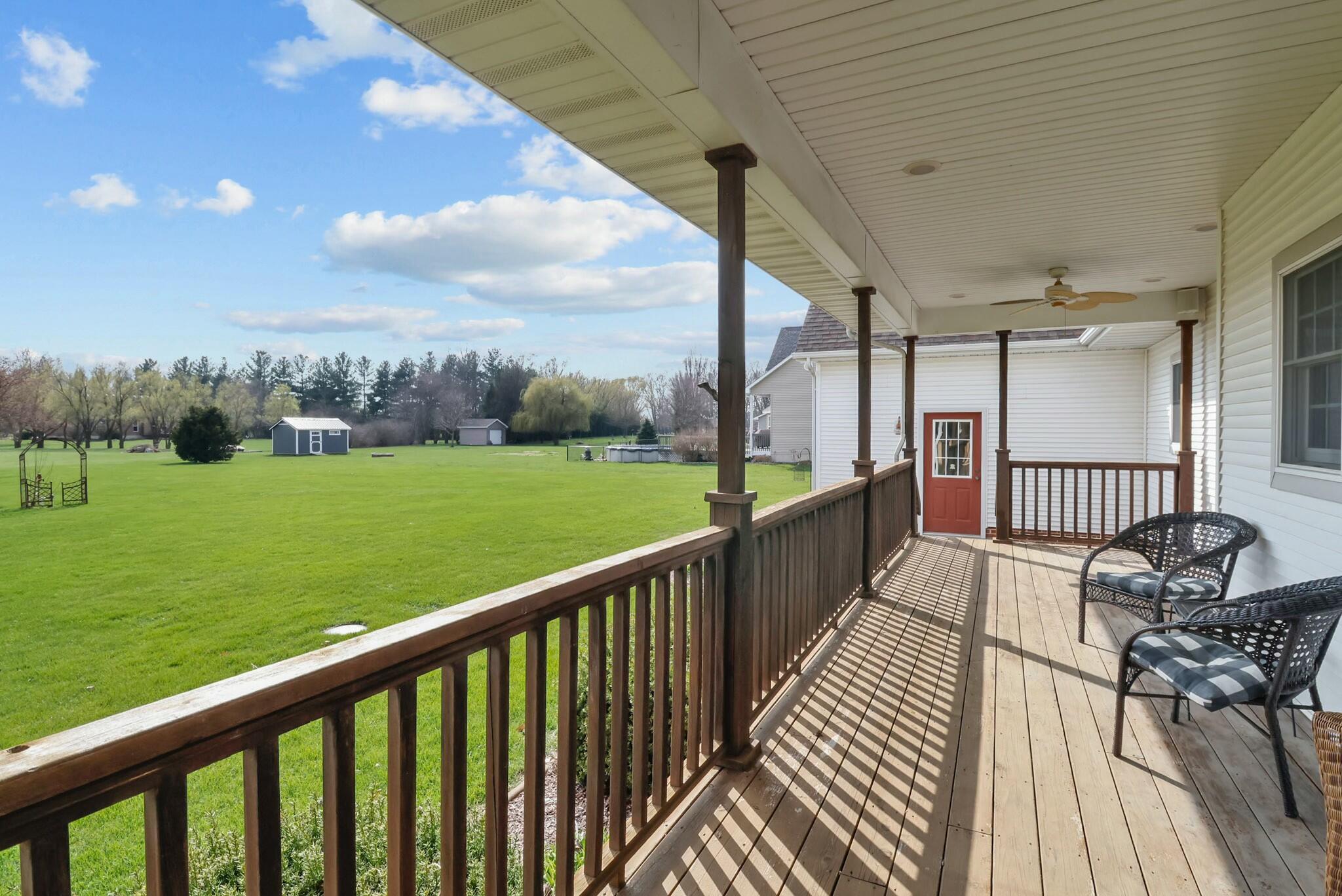 172 Lee Drive Kouts, IN 46347 - Photo 57 of 63 a view of a porch with wooden floor and outdoor seating