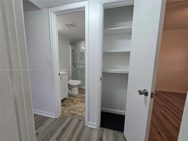 a view of a bathroom from a hallway