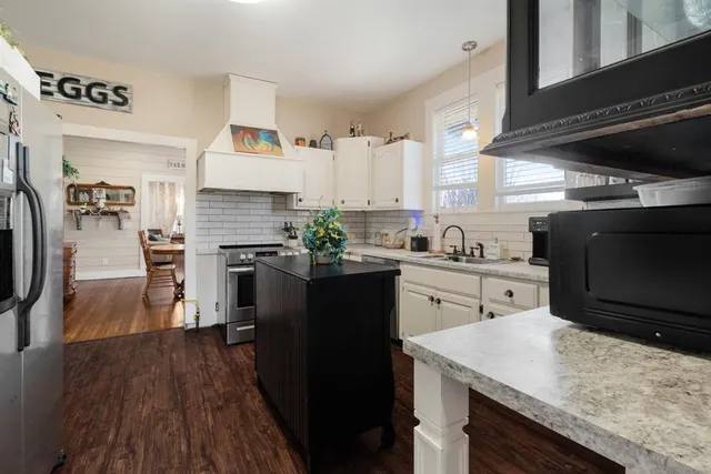a kitchen with granite countertop counter space a sink appliances and cabinets