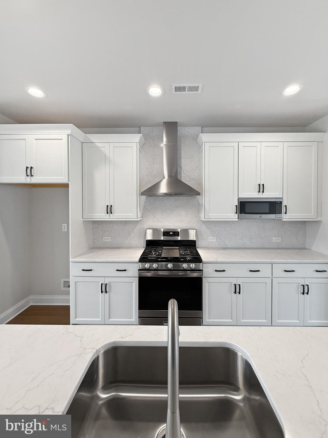 3 Schadle Road Perkasie, PA 18944 - Photo 6 of 40 a kitchen with granite countertop white cabinets and black appliances