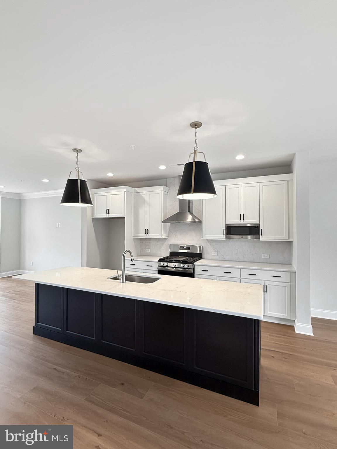 3 Schadle Road Perkasie, PA 18944 - Photo 8 of 40 a kitchen with stainless steel appliances a sink stove and wooden floor