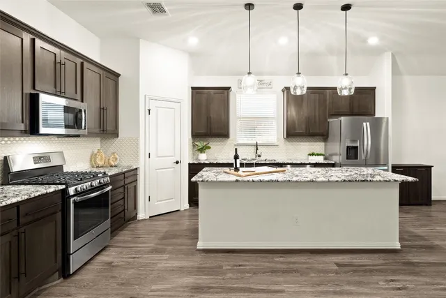 a living room with furniture a table and large windows