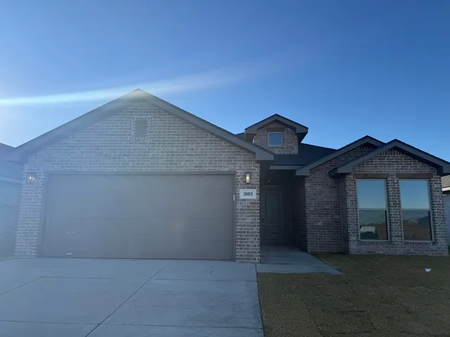 a view of a house with a yard and garage