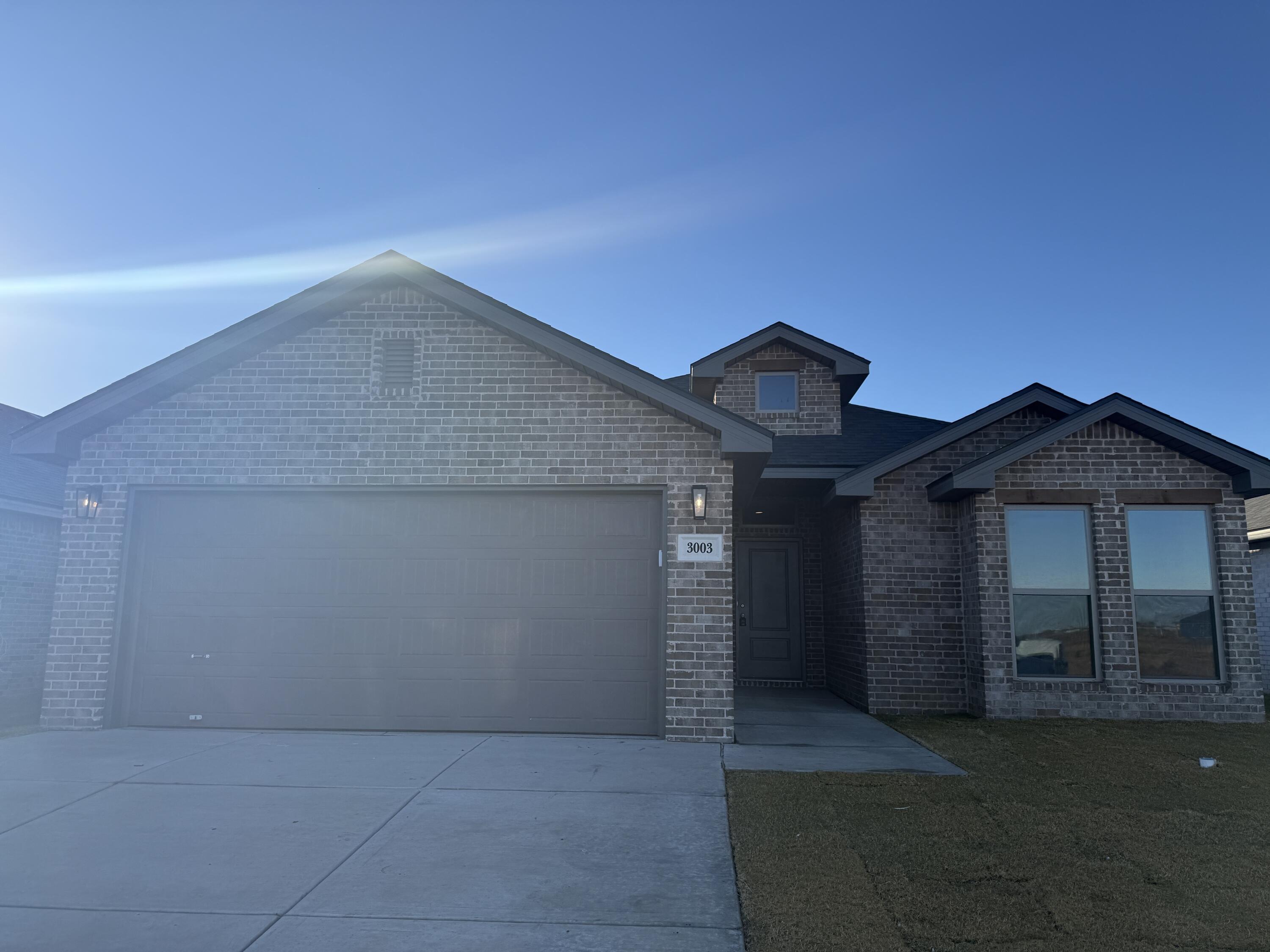 3003 138th Place Lubbock, TX 79423 - Photo 1 of 14 a view of a house with a yard and garage