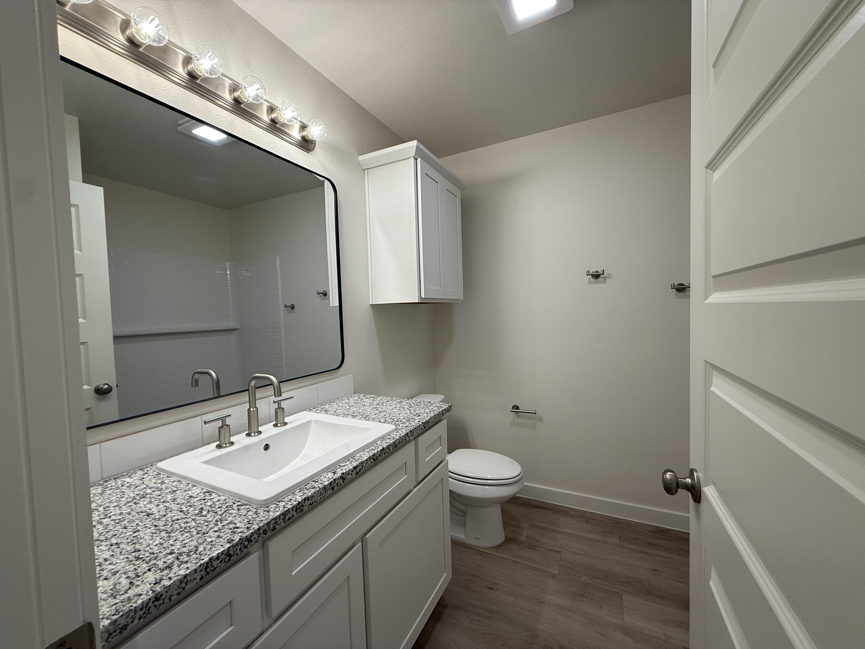 3003 138th Place Lubbock, TX 79423 - Photo 11 of 14 a bathroom with a sink toilet and mirror