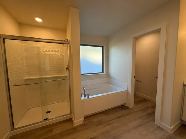 a bathroom with a bathtub and a shower
