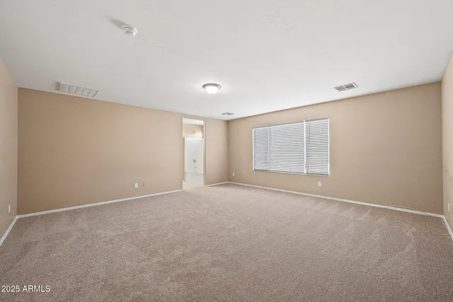 a bathroom with a granite countertop sink toilet and mirror