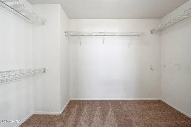 a spacious bathroom with a tub a sink and mirror