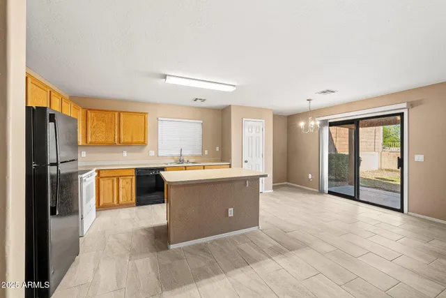 a large kitchen with a refrigerator and a stove