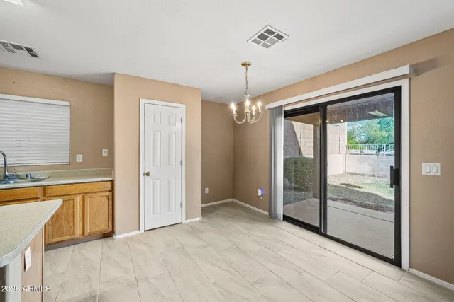 a view of kitchen with stainless steel appliances granite countertop a refrigerator and a stove top oven