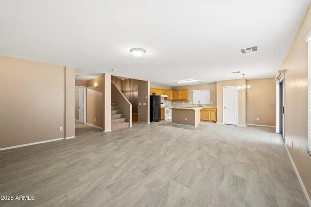 a view of a kitchen with granite countertop a refrigerator and a sink