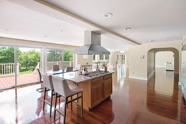 a dining room with furniture a chandelier and wooden floor