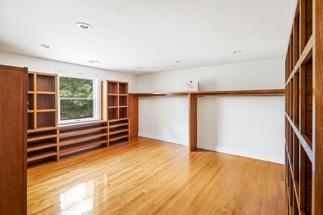 a view of room with wooden floor and stairs